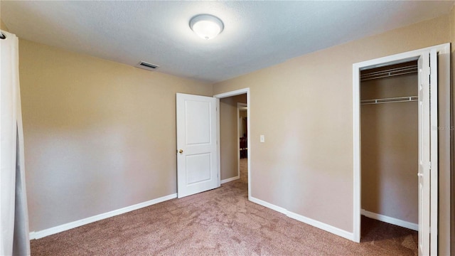 410 Orange St, Bradley, FL 33835 - unfurnished bedroom featuring baseboards, visible vents, carpet floors, and a closet