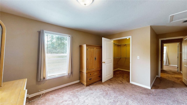 410 Orange St, Bradley, FL 33835 - unfurnished bedroom featuring light colored carpet, baseboards, a walk in closet, and a closet