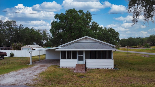 410 Orange St, Bradley, FL 33835 - bungalow-style house with dirt driveway, a sunroom, a front lawn, and a carport