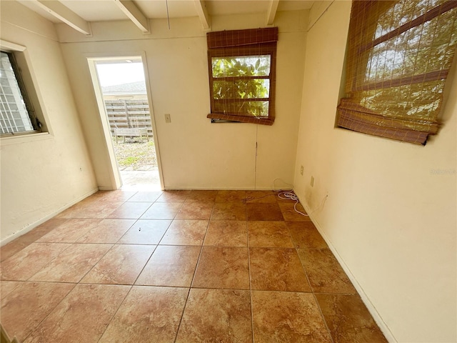 2415 Goldenrod St, Sarasota, FL 34239 - unfurnished room featuring plenty of natural light, beam ceiling, and tile patterned flooring