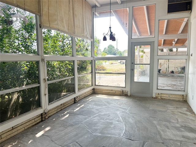 2415 Goldenrod St, Sarasota, FL 34239 - unfurnished sunroom featuring stone floors and a wall mounted air conditioner