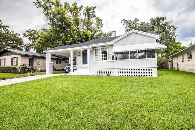422 E Belmar St, Lakeland, FL 33803 - ranch-style home featuring a front lawn, driveway, a chimney, and a carport