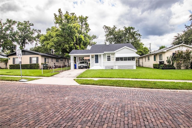 422 E Belmar St, Lakeland, FL 33803 - bungalow-style house featuring fence, a carport, driveway, and a front yard