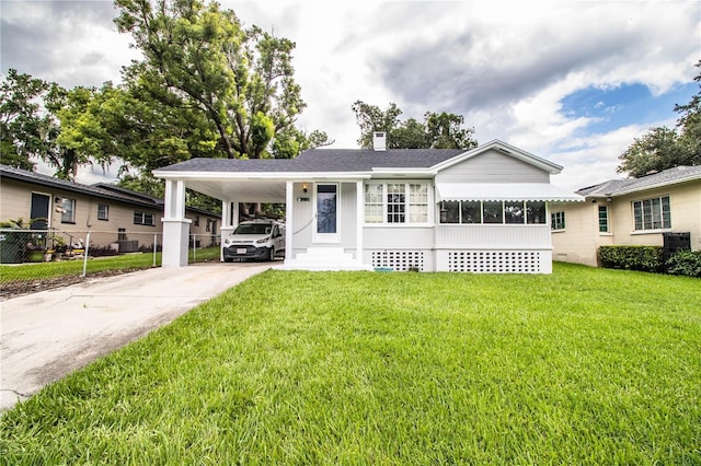 422 E Belmar St, Lakeland, FL 33803 - single story home with fence, driveway, a front yard, and a carport