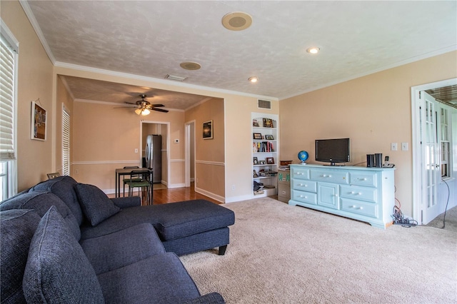422 E Belmar St, Lakeland, FL 33803 - living room featuring a ceiling fan, visible vents, crown molding, baseboards, and carpet