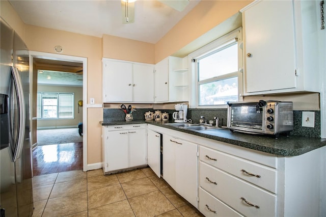422 E Belmar St, Lakeland, FL 33803 - kitchen with dark countertops, a sink, stainless steel fridge with ice dispenser, a toaster, and white cabinetry