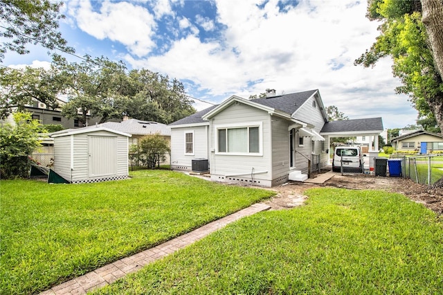 422 E Belmar St, Lakeland, FL 33803 - back of property featuring crawl space, a storage shed, central air condition unit, fence, and a shingled roof