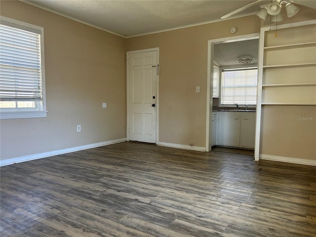 422 E Belmar St, Lakeland, FL 33803 - interior space with ceiling fan, a textured ceiling, baseboards, dark wood-type flooring, and ornamental molding