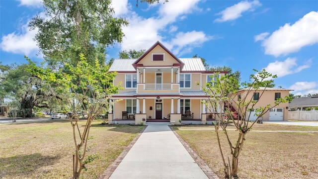410 S Broadway Ave, Bartow, FL 33830 - victorian-style house featuring covered porch, a front lawn, and metal roof