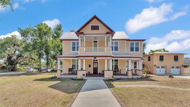 410 S Broadway Ave, Bartow, FL 33830 - victorian home with a porch, metal roof, a front yard, a garage, and driveway