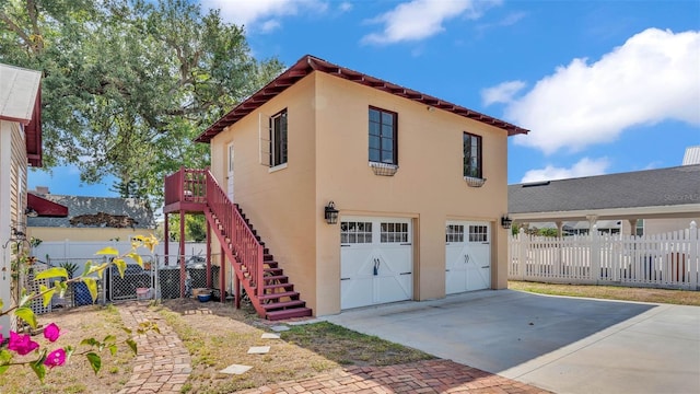 410 S Broadway Ave, Bartow, FL 33830 - view of home's exterior featuring an attached garage, fence, concrete driveway, and stairs