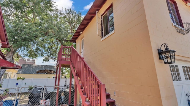 410 S Broadway Ave, Bartow, FL 33830 - view of property exterior with fence, stairway, and concrete block siding