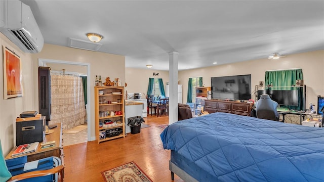410 S Broadway Ave, Bartow, FL 33830 - bedroom with a wall mounted AC, ornate columns, and wood finished floors