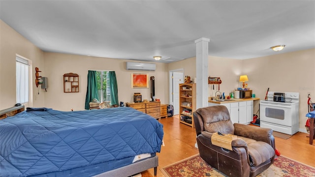 410 S Broadway Ave, Bartow, FL 33830 - bedroom featuring a wall mounted AC, a sink, and light wood finished floors