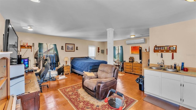 410 S Broadway Ave, Bartow, FL 33830 - bedroom with a wall mounted air conditioner, a sink, and light wood-style flooring