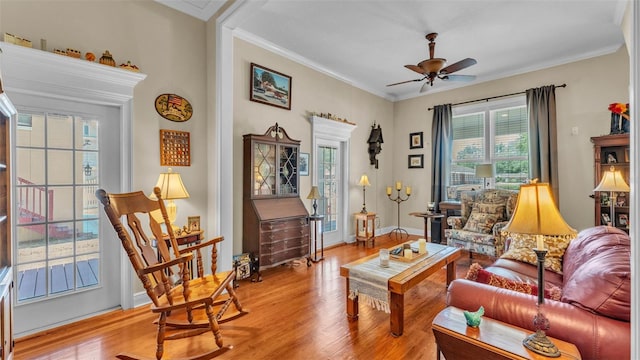 410 S Broadway Ave, Bartow, FL 33830 - living area with light wood-type flooring, a ceiling fan, crown molding, and baseboards