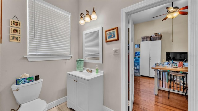 410 S Broadway Ave, Bartow, FL 33830 - bathroom with toilet, a ceiling fan, baseboards, vanity, and wood finished floors