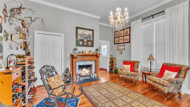 410 S Broadway Ave, Bartow, FL 33830 - sitting room with wood finished floors, a chandelier, crown molding, and a fireplace