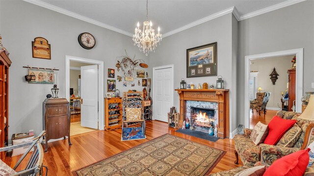 410 S Broadway Ave, Bartow, FL 33830 - living area featuring a premium fireplace, wood finished floors, ornamental molding, and a chandelier