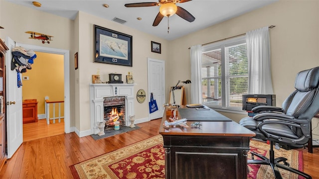 410 S Broadway Ave, Bartow, FL 33830 - home office featuring a fireplace with flush hearth, wood finished floors, a ceiling fan, and baseboards