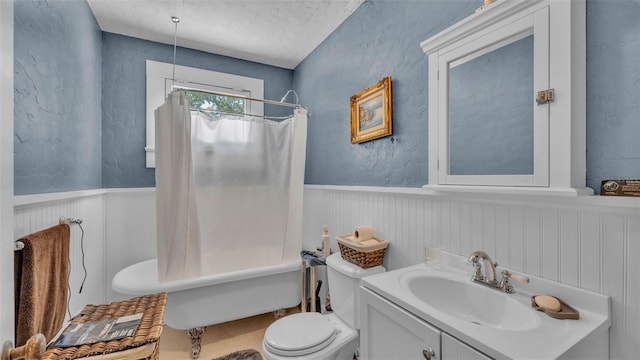 410 S Broadway Ave, Bartow, FL 33830 - full bath with wainscoting, toilet, vanity, a textured ceiling, and shower / bath combo