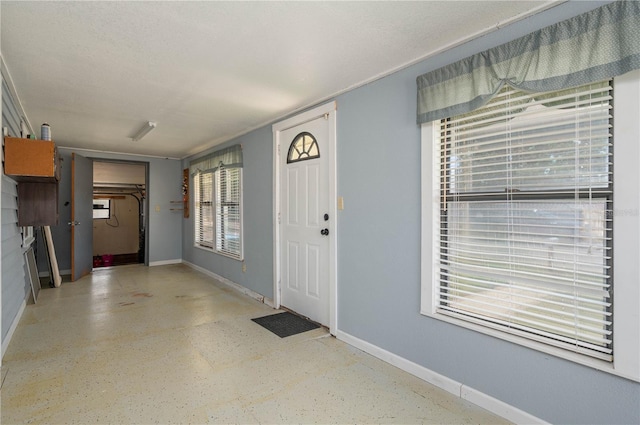 entryway featuring baseboards
