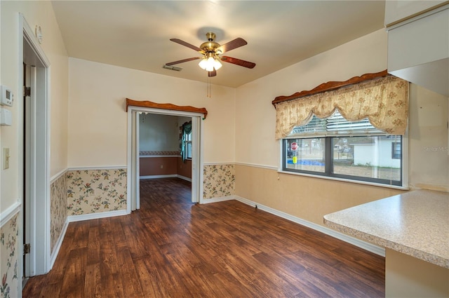 interior space featuring baseboards, ceiling fan, wood finished floors, and visible vents