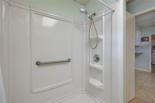 full bath with tile patterned floors and walk in shower
