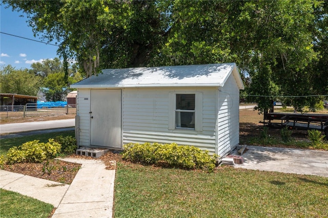 view of shed featuring fence