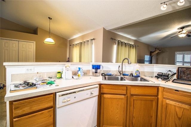 kitchen featuring lofted ceiling, a sink, light countertops, dishwasher, and a ceiling fan