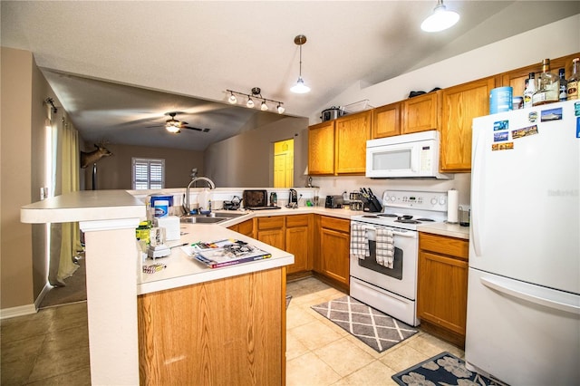 kitchen with white appliances, a sink, a peninsula, light tile patterned flooring, and lofted ceiling