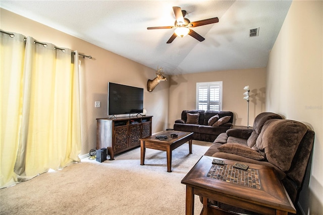 living area featuring visible vents, a ceiling fan, vaulted ceiling, and light carpet