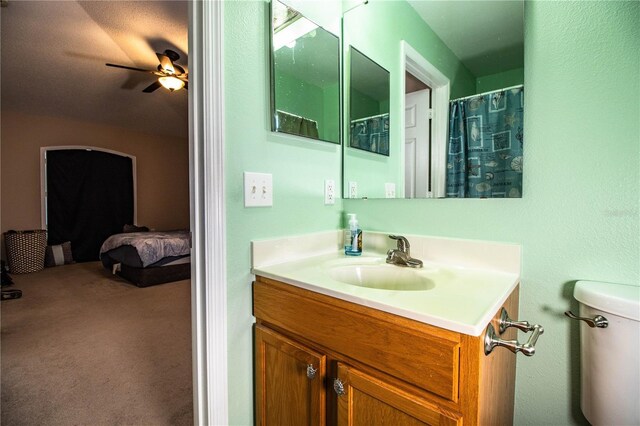full bathroom featuring ceiling fan, toilet, ensuite bathroom, and vanity