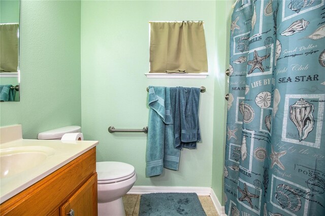 full bathroom featuring curtained shower, baseboards, toilet, vanity, and tile patterned flooring