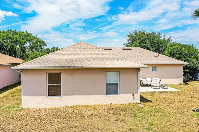back of property featuring a patio, outdoor lounge area, a shingled roof, a lawn, and stucco siding