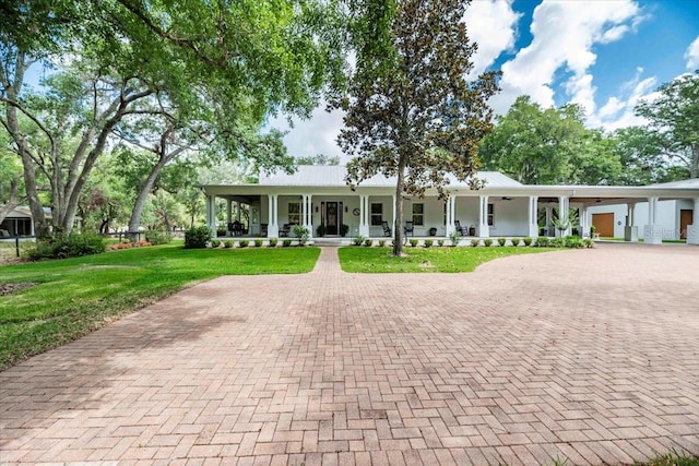 single story home featuring a porch, decorative driveway, and a front lawn