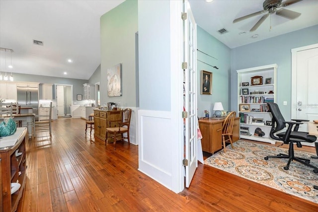 office space featuring ceiling fan, visible vents, high vaulted ceiling, and hardwood / wood-style floors