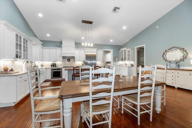 dining area with recessed lighting, visible vents, dark wood-style floors, and lofted ceiling