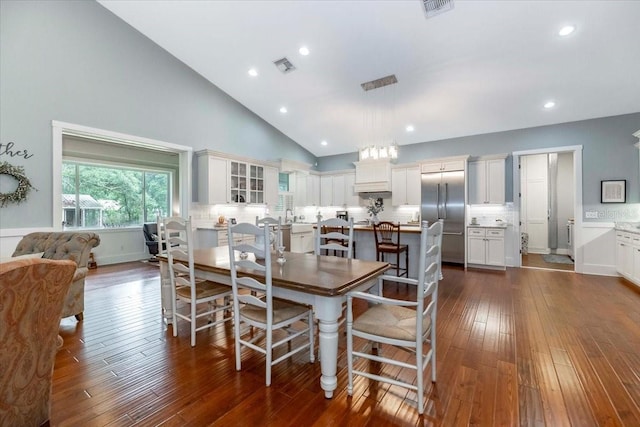 dining room with recessed lighting, high vaulted ceiling, dark wood-style flooring, and visible vents