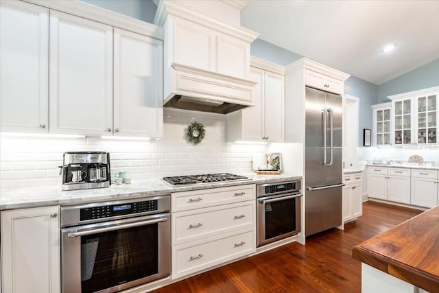 kitchen featuring glass insert cabinets, appliances with stainless steel finishes, and white cabinets