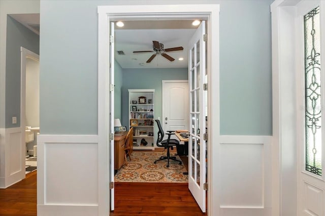 corridor with visible vents and dark wood-style floors