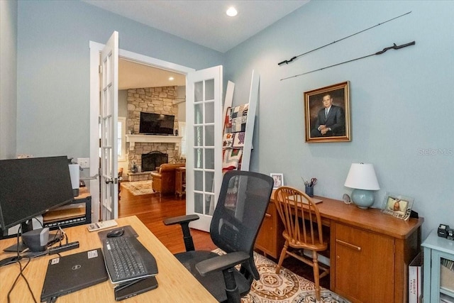 office area with recessed lighting, wood finished floors, and a fireplace