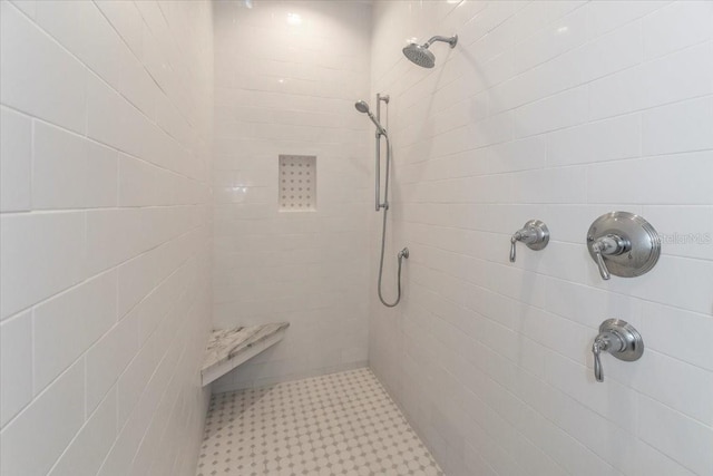 full bath with tile patterned floors and tiled shower