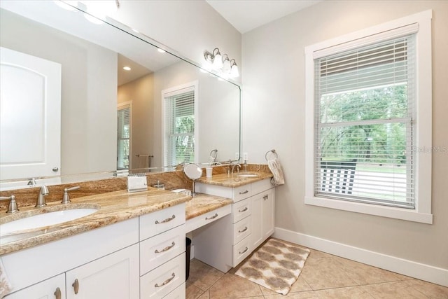 full bathroom featuring baseboards, a sink, and a wealth of natural light