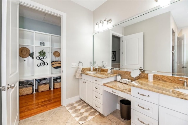 full bathroom featuring a sink, tile patterned floors, and double vanity