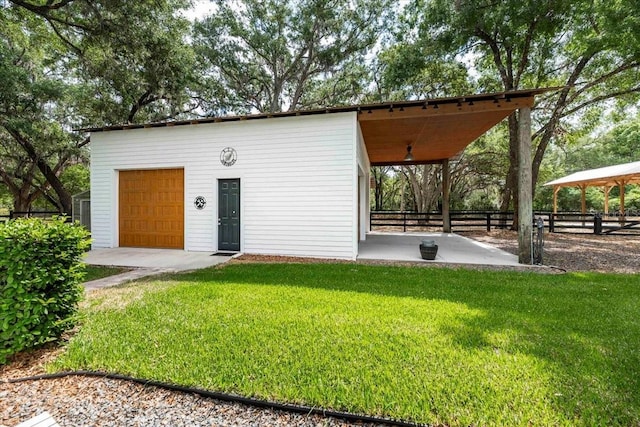 view of outbuilding with fence and an outdoor structure
