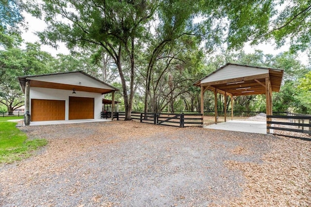 view of community with an exterior structure, an outdoor structure, and a detached garage