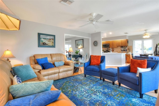 4116 4th Ave NE, Bradenton, FL 34208 - living room with a ceiling fan, wood finished floors, and visible vents
