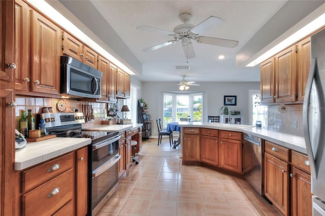 4116 4th Ave NE, Bradenton, FL 34208 - kitchen featuring a peninsula, recessed lighting, a sink, backsplash, and stainless steel appliances