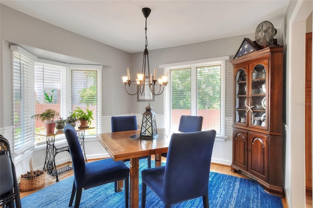4116 4th Ave NE, Bradenton, FL 34208 - dining space featuring a healthy amount of sunlight, dark wood-type flooring, and a notable chandelier